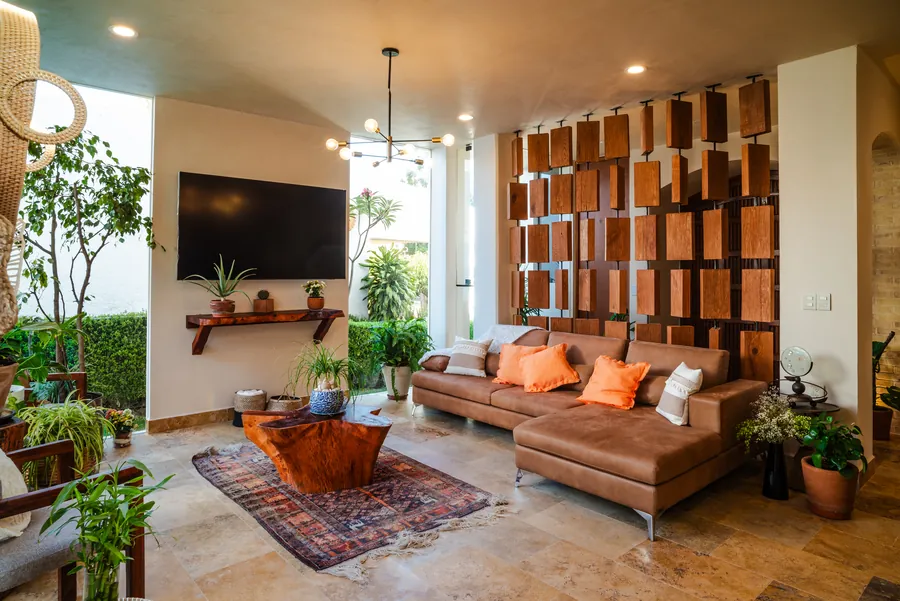 Sala con sofá de piel y librero de madera a doble altura — casa residencial de autor en Atlixco, Puebla